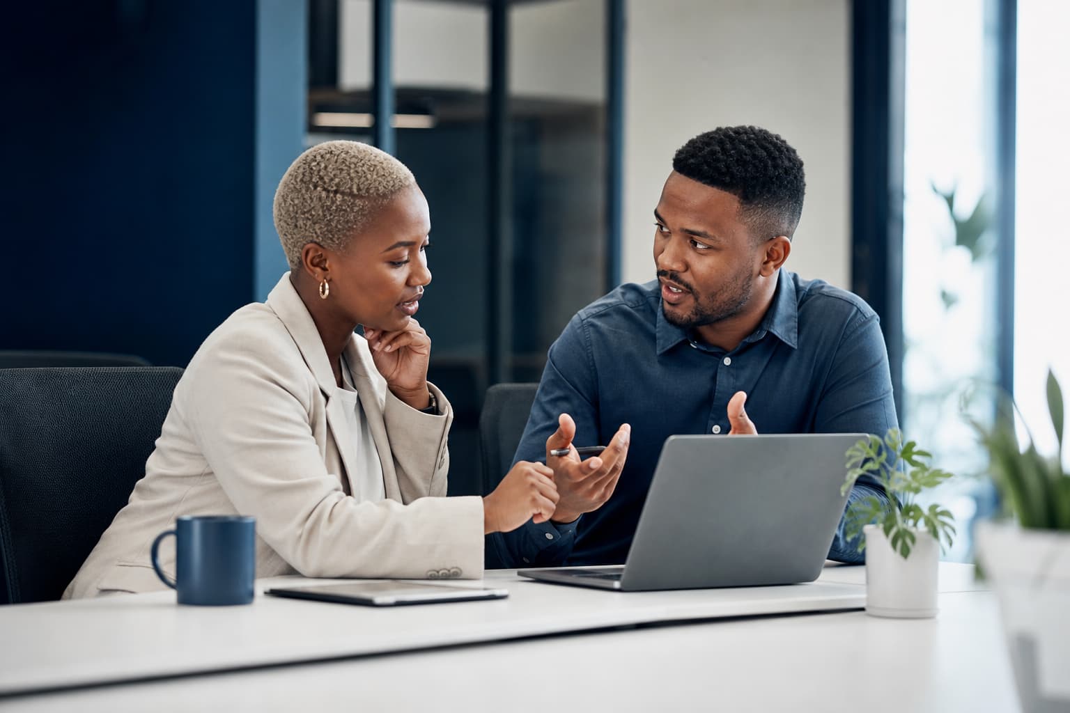 Small business owner reviewing business technology procurement options with a technology adviser
